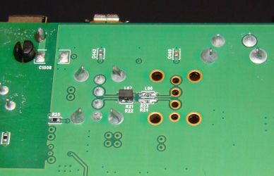 D-Link DIR-825 with bridges soldered to enable second USB port